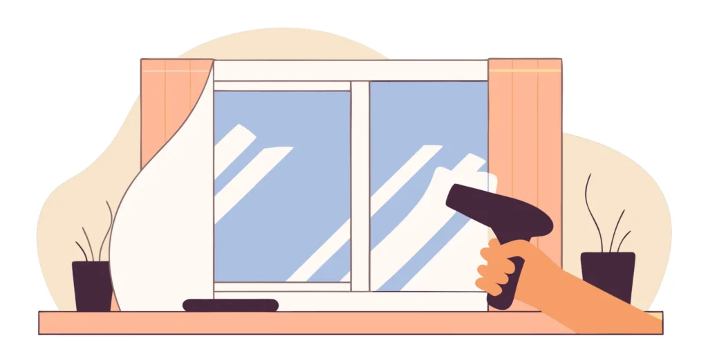 Installing a window insulation kit by shrinking the film with a hair dryer.